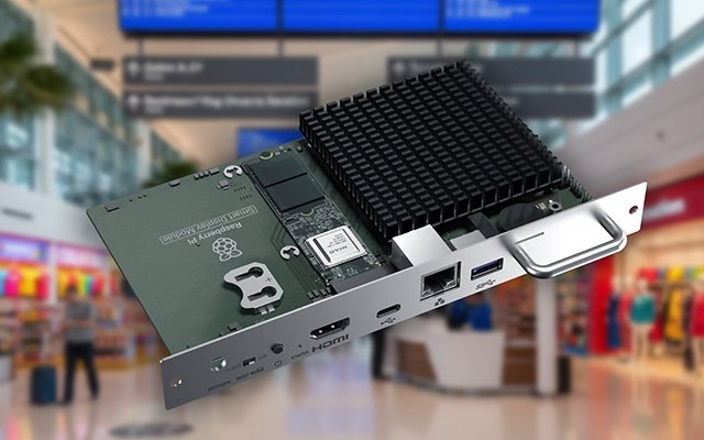 Sharp SDM MPi5 computing module pictured against an airport information-display setting