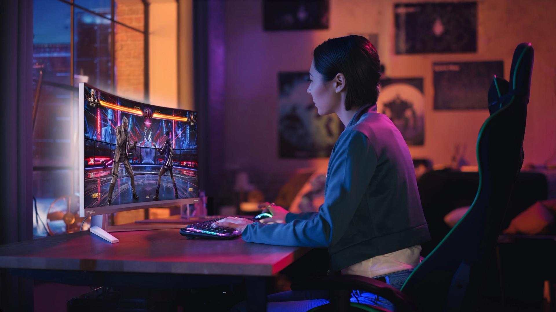 A player uses the curved Philips Evnia 34M2C8600P in a gaming setup with coloured ambient lighting.