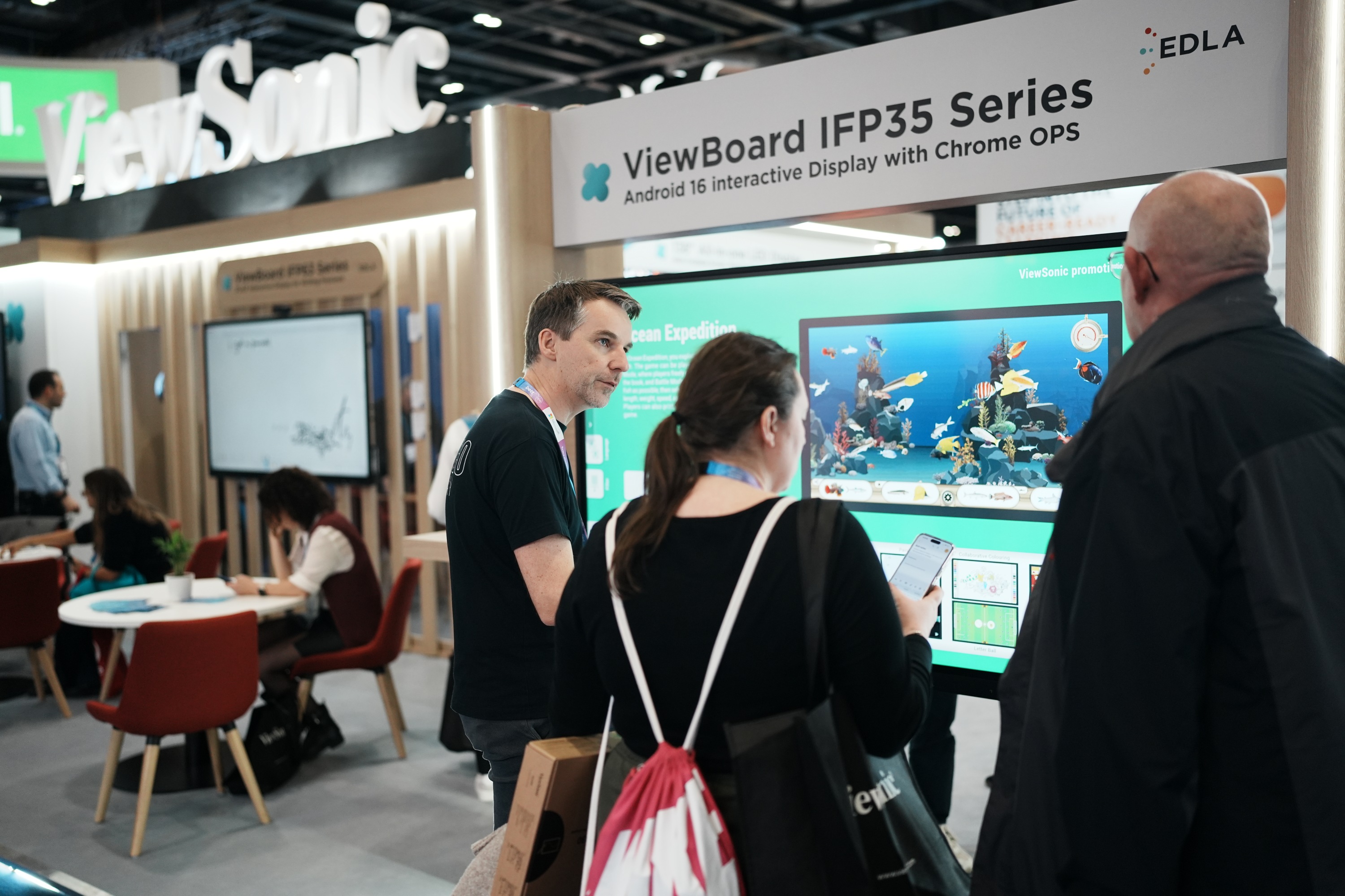 Visitors at the ViewSonic Bett stand watching an IFP35 Series interactive display demonstration