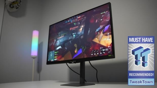 GIGABYTE G27U showing a game on a desk, alongside the original TweakTown award badge