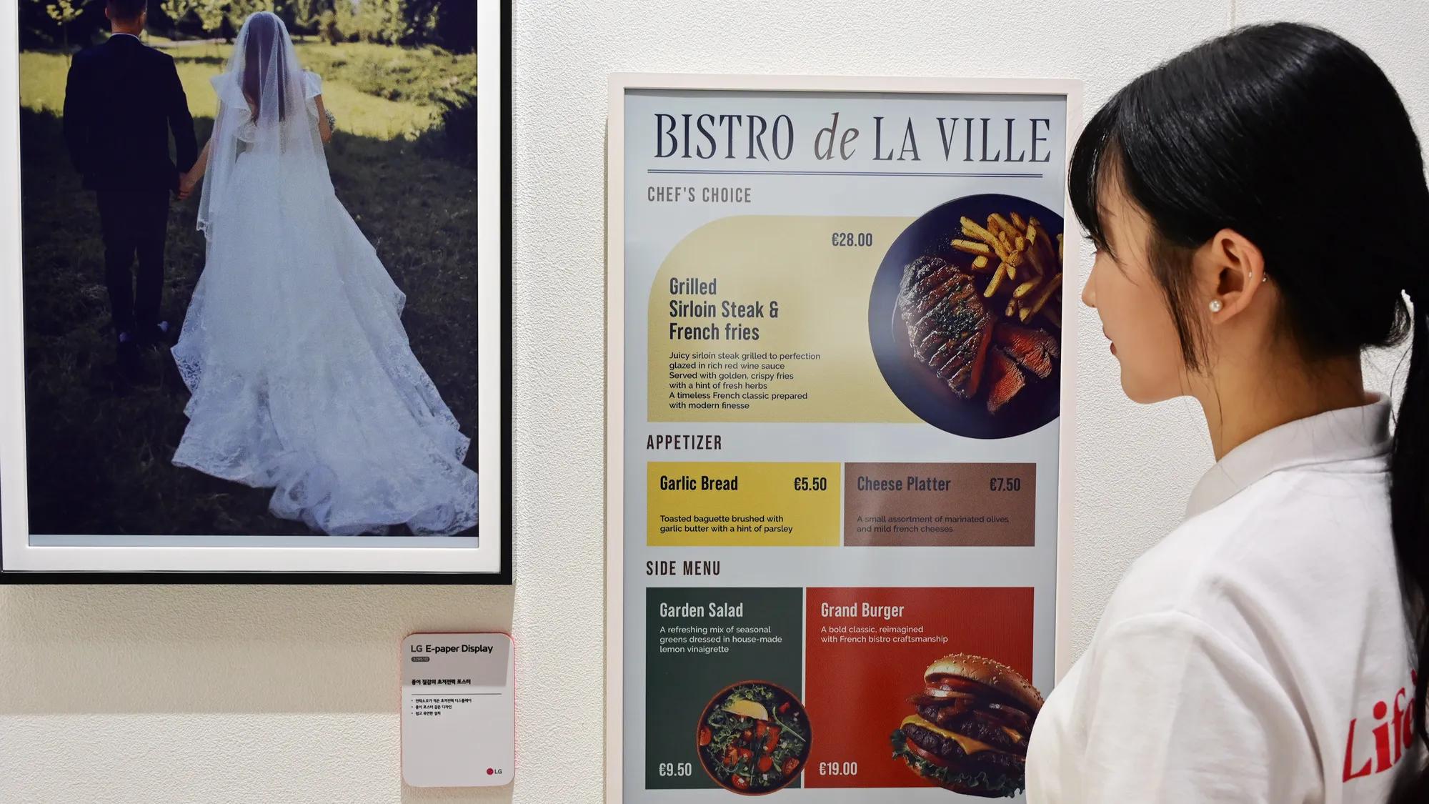 Visitor viewing an LG E-Paper display showing a restaurant menu