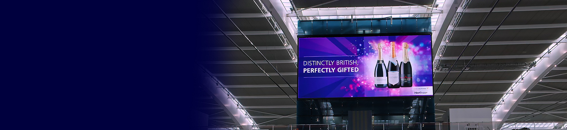 Large suspended LED advertising screen inside Heathrow Terminal 5