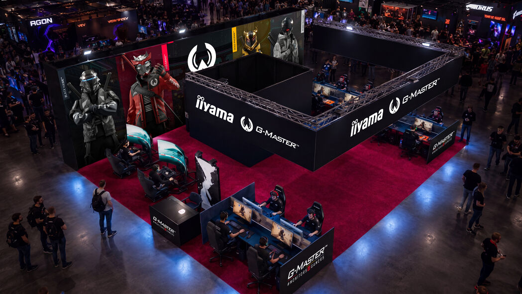 iiyama G-Master exhibition stand pictured in the original gamescom announcement, with racing and gaming stations.